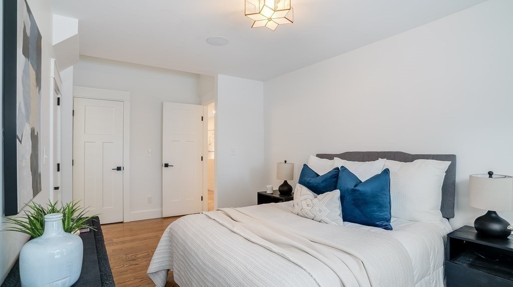 38 Chester Street, Unit 1 Somerville, MA 02144 - Photo 18 of 32 a bedroom with a bed and a potted plant