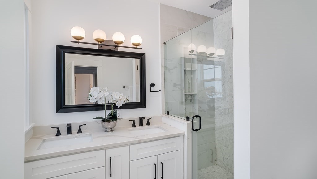 38 Chester Street, Unit 1 Somerville, MA 02144 - Photo 19 of 32 a bathroom with a sink vanity granite and a mirror
