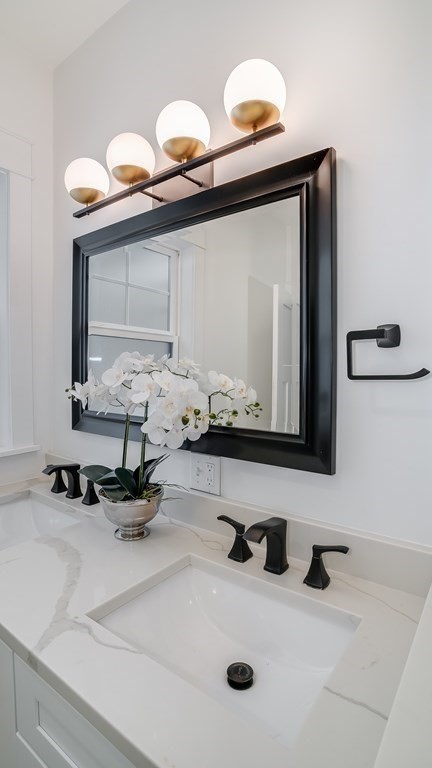 38 Chester Street, Unit 1 Somerville, MA 02144 - Photo 22 of 32 a bathroom with a sink and a mirror