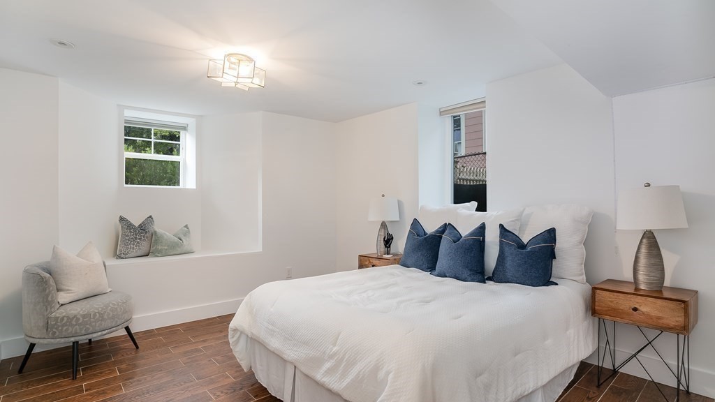38 Chester Street, Unit 1 Somerville, MA 02144 - Photo 24 of 32 a bedroom with a bed and wooden floor