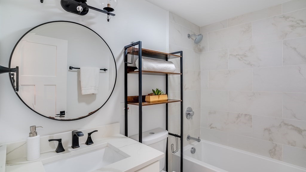 38 Chester Street, Unit 1 Somerville, MA 02144 - Photo 26 of 32 a bathroom with a sink toilet and a mirror