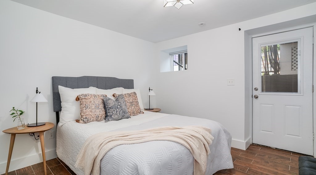 38 Chester Street, Unit 1 Somerville, MA 02144 - Photo 27 of 32 a bedroom with a bed and wooden floor
