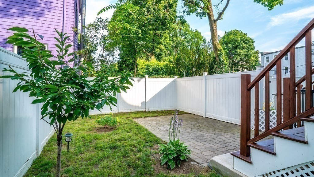 38 Chester Street, Unit 1 Somerville, MA 02144 - Photo 30 of 32 a backyard of a house with lots of green space
