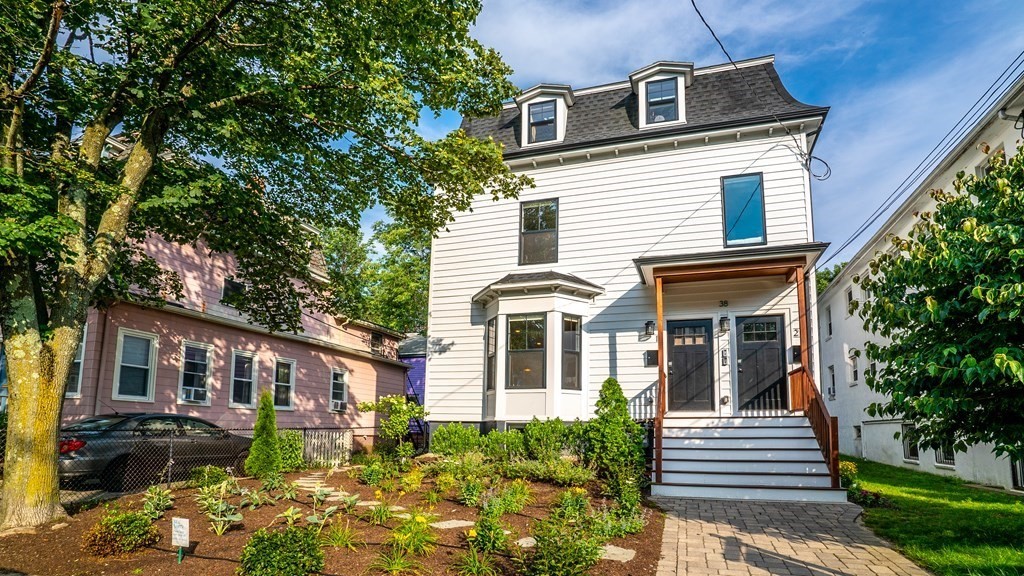 38 Chester Street, Unit 1 Somerville, MA 02144 - Photo 3 of 32 a front view of a house with a yard