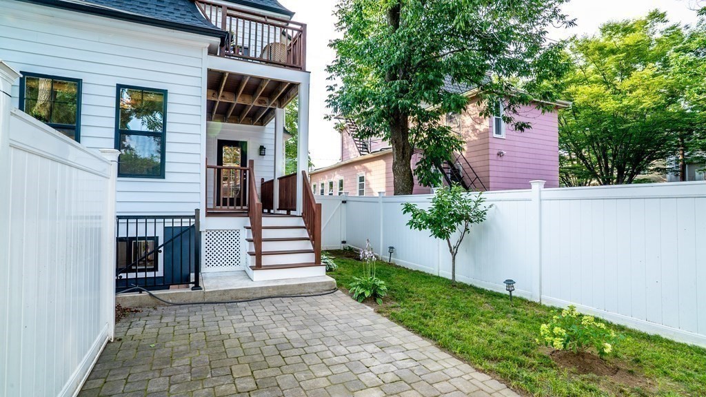 38 Chester Street, Unit 1 Somerville, MA 02144 - Photo 31 of 32 a front view of a house with a yard