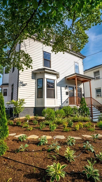 38 Chester Street, Unit 1 Somerville, MA 02144 - Photo 4 of 32 a front view of a house with a yard