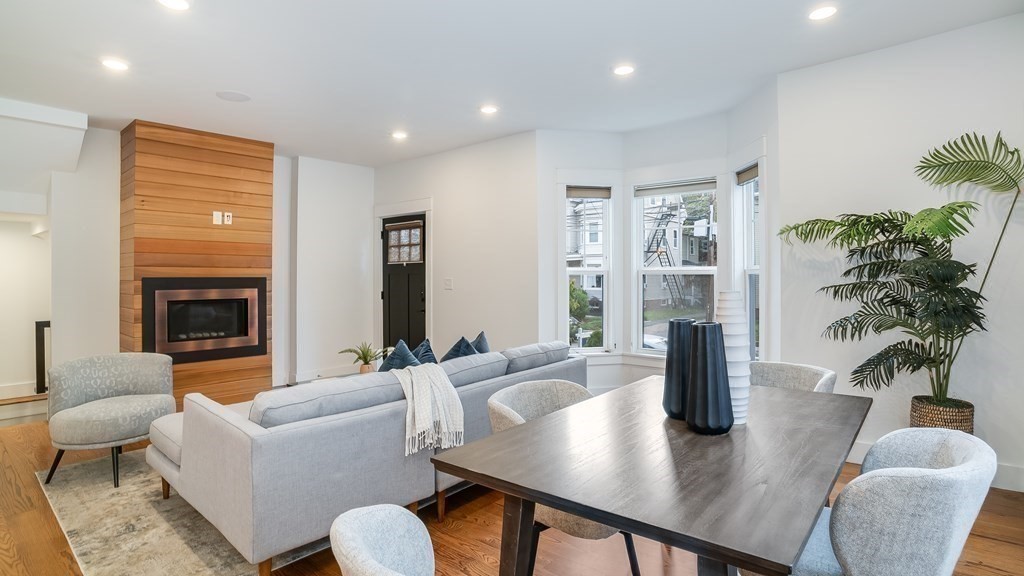 38 Chester Street, Unit 1 Somerville, MA 02144 - Photo 7 of 32 a living room with furniture potted plant and a fireplace