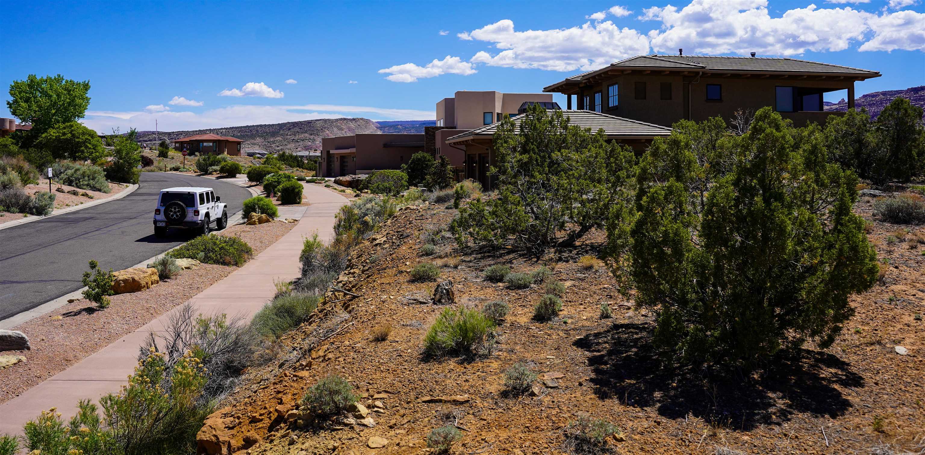 353 High Desert Road Grand Junction, CO 81507 - Photo 4 of 15 a view of a house with a yard and a pond