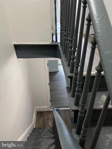 a view of an empty room and wooden floor