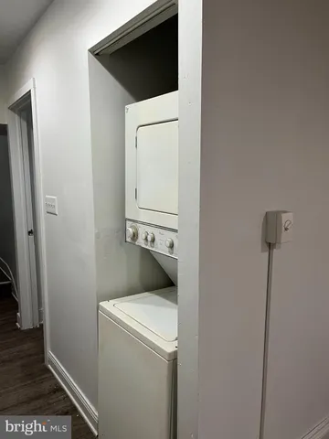 an empty room with wooden floor and cabinet