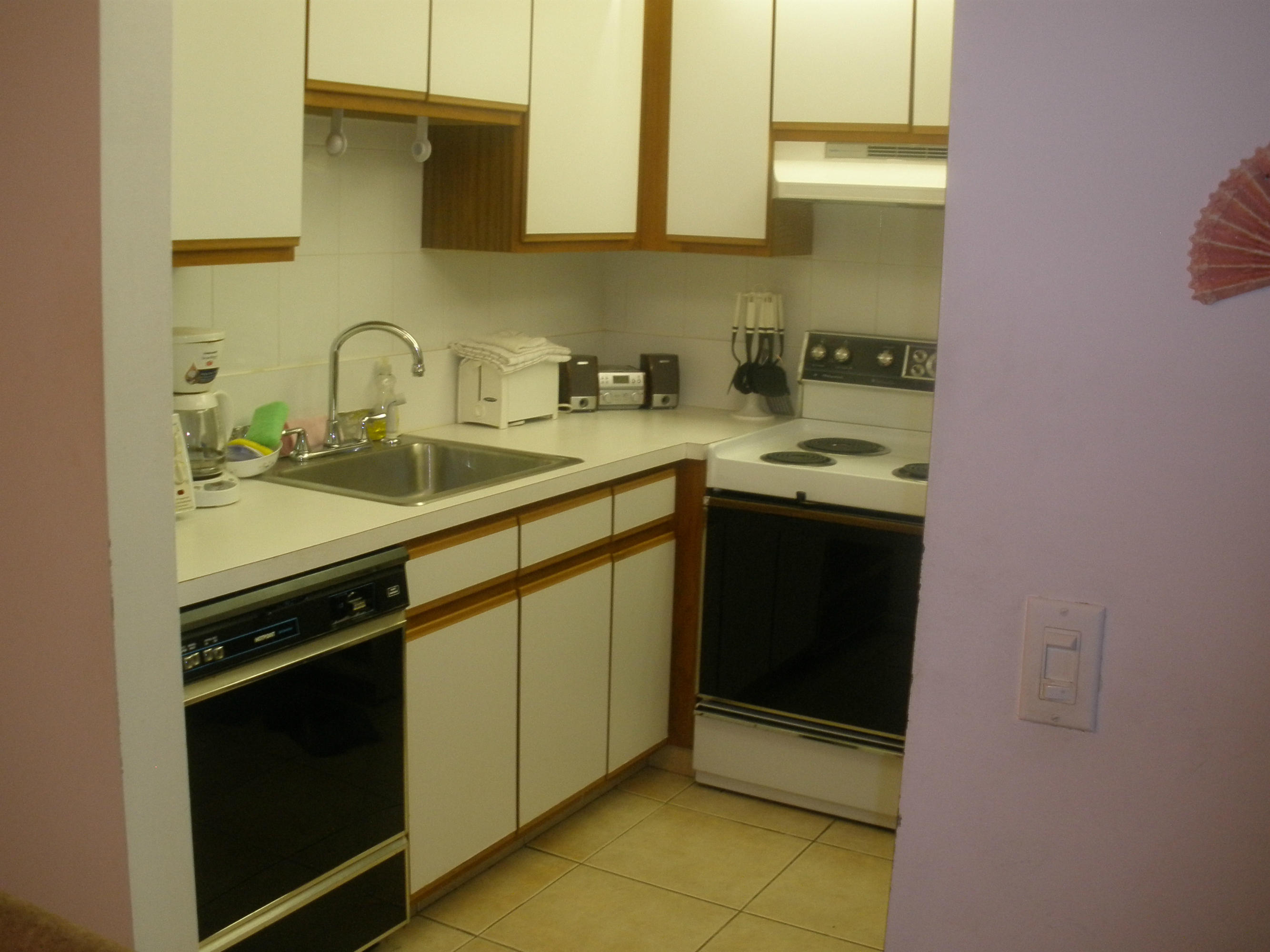 492 Mansfield K Boca Raton, FL 33434 - Photo 5 of 11 a kitchen with stainless steel appliances a sink stove and cabinets