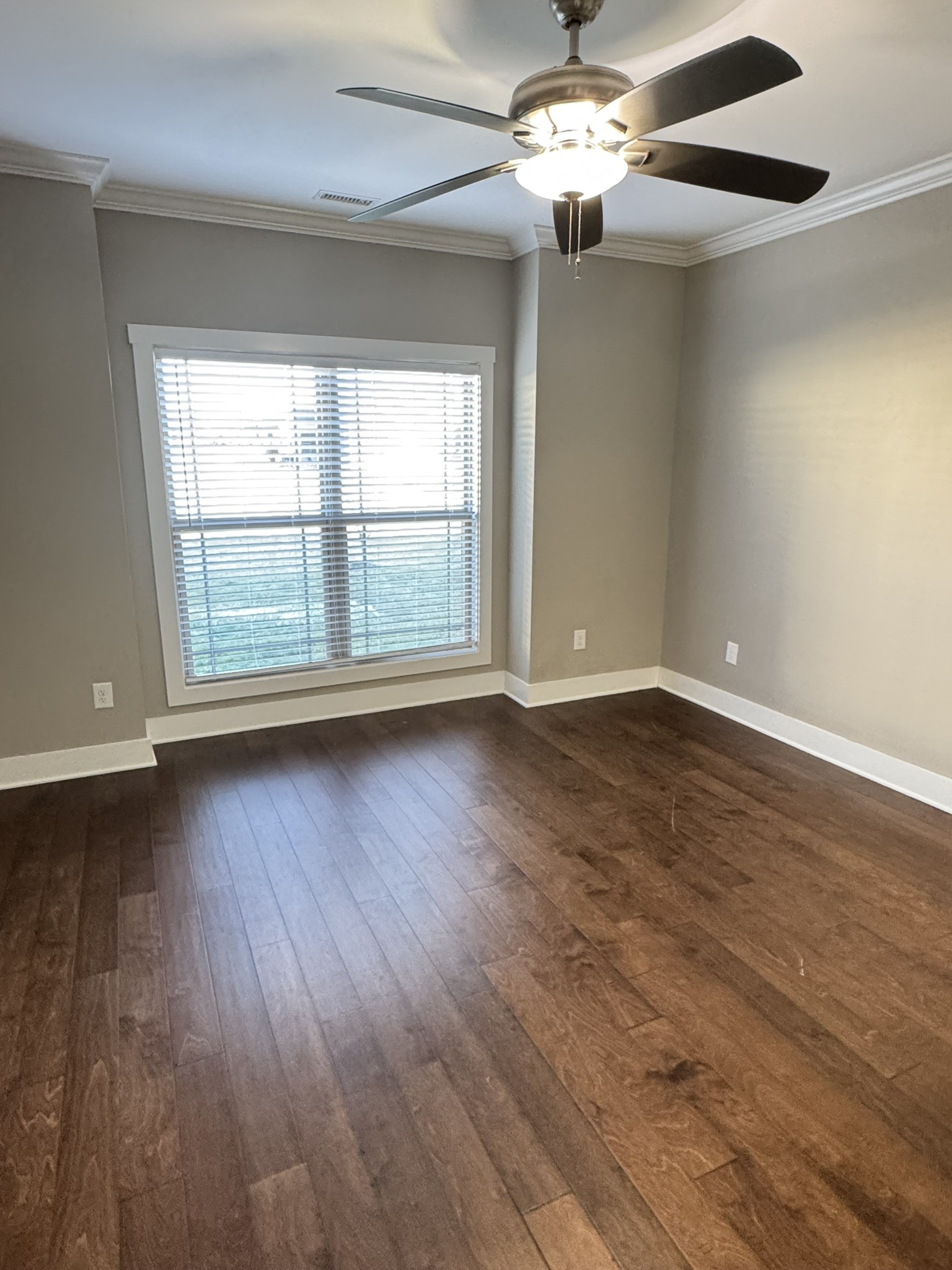 148 ANDERTON Drive Winchester, TN 37398 - Photo 6 of 16 an empty room with wooden floor chandelier fan and windows