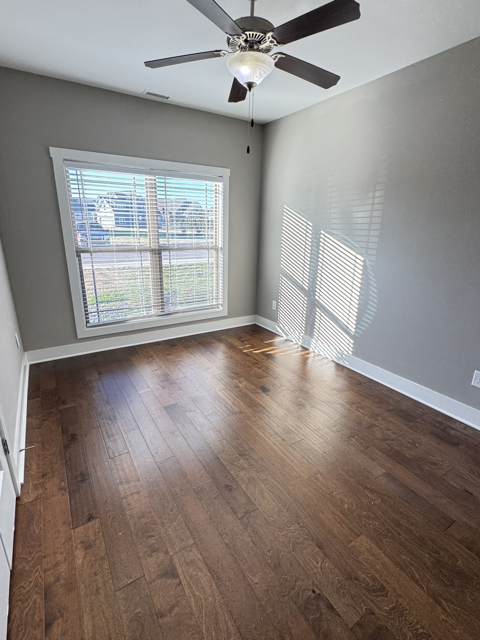 148 ANDERTON Drive Winchester, TN 37398 - Photo 8 of 16 an empty room with wooden floor fan and windows