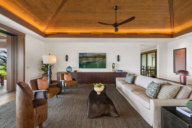 a living room with furniture and a dining room