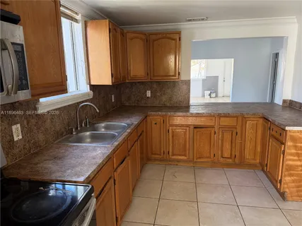 a kitchen with a sink stove and cabinets