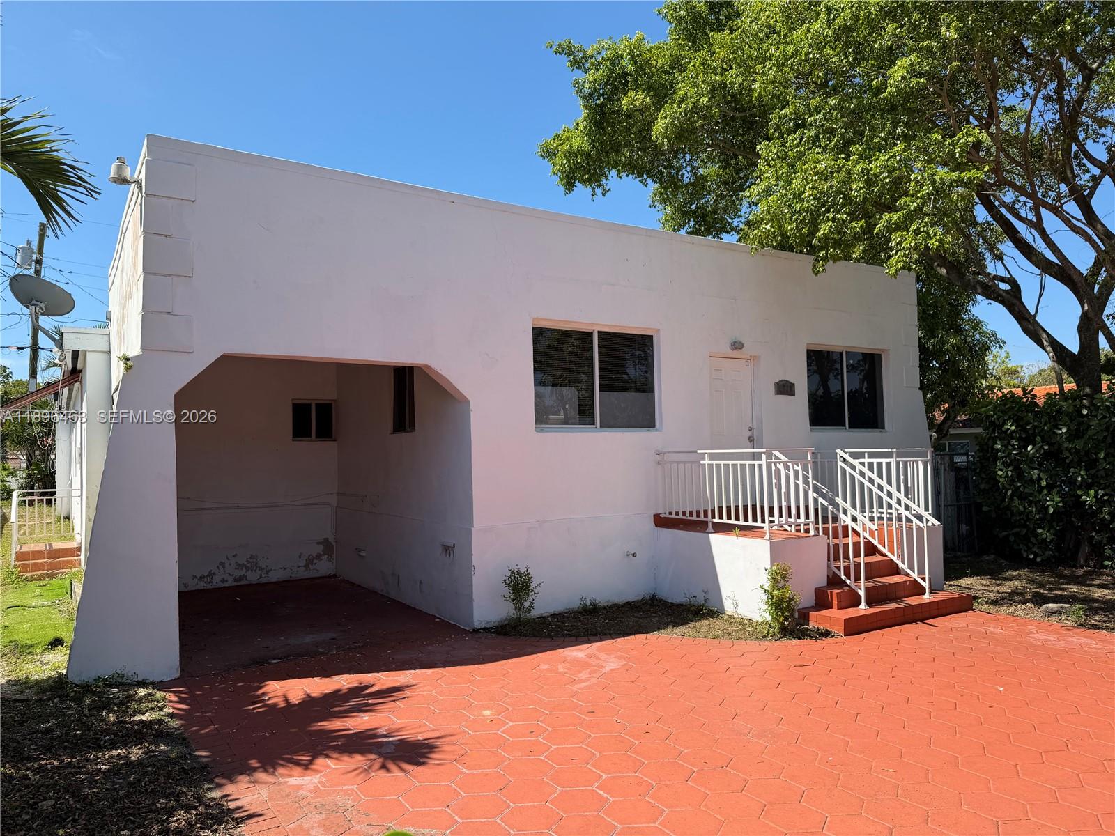 1738 Southwest 17th Street Miami, FL 33145 - Photo 29 of 29 a front view of house with yard outdoor seating and covered with trees