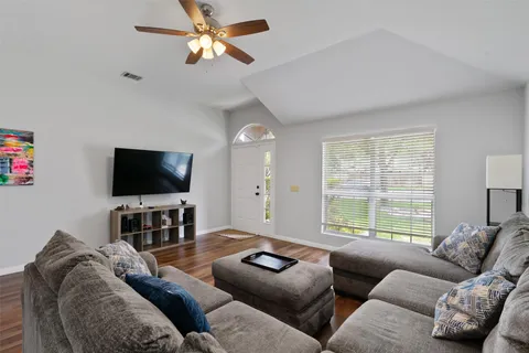 a living room with furniture and a flat screen tv