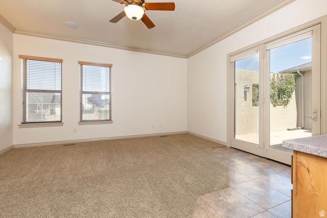 888 East Fiddlers Canyon Road Cedar City, UT 84721 - Photo 23 of 74 Empty room featuring a ceiling fan, crown molding, light tile patterned floors, and light carpet