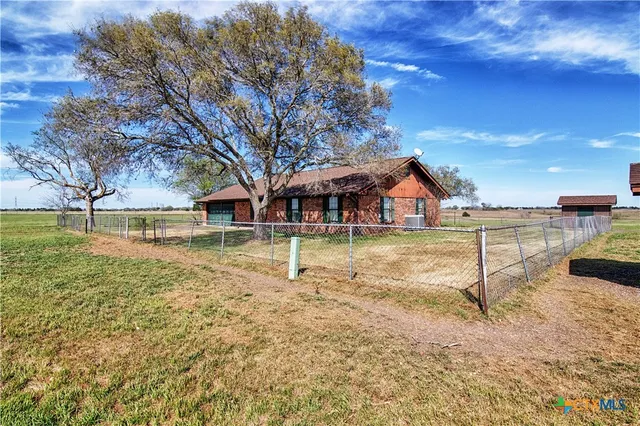 a front view of a house with swimming pool having outdoor seating