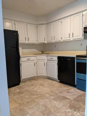 a kitchen with a refrigerator and cabinets
