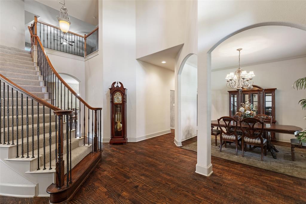 1217 Windmere Way Allen, TX 75013 - Photo 9 of 38 A sweeping staircase, soaring ceilings, and rich hardwoods create a grand first impression the moment guests step inside.
