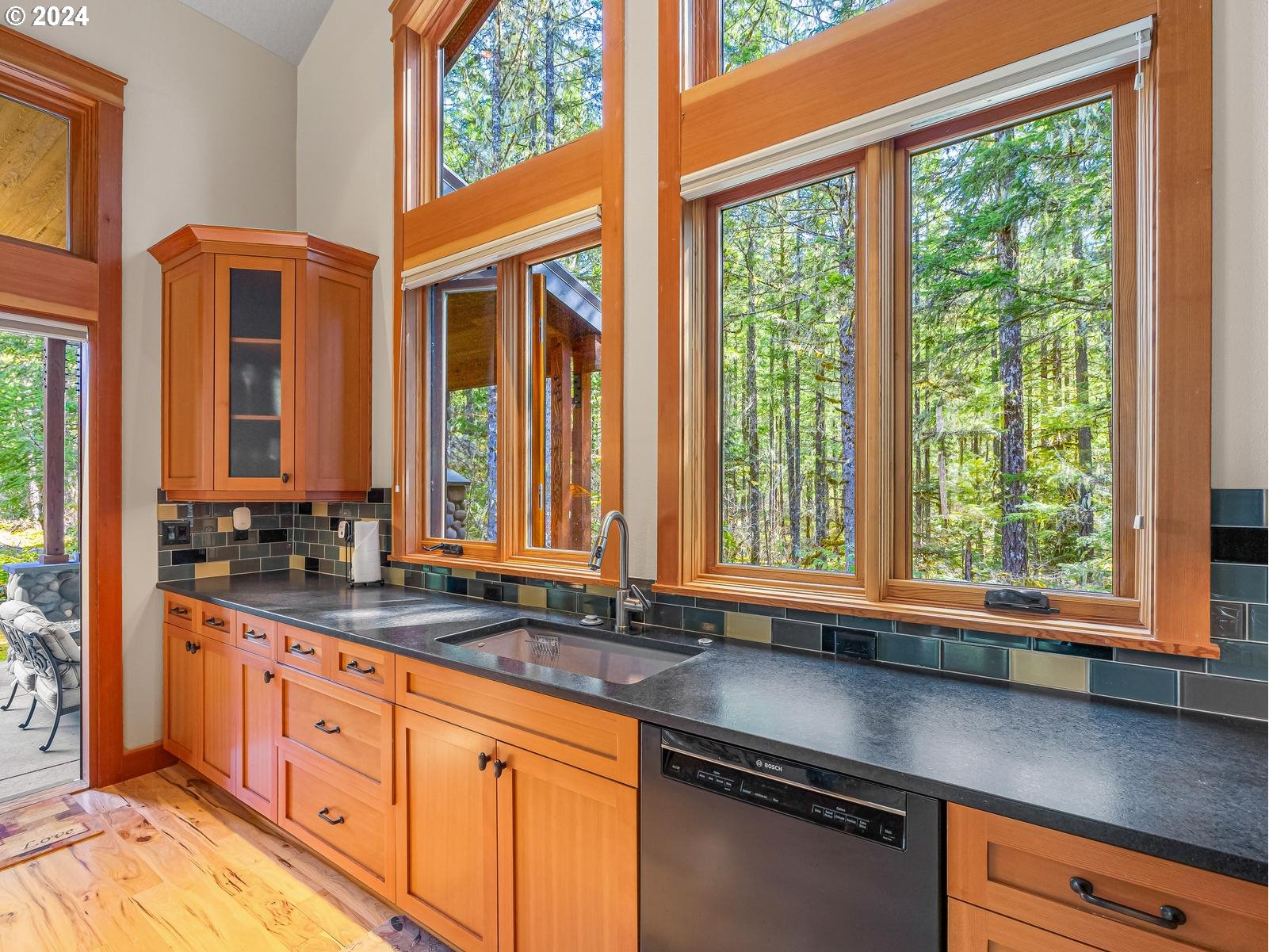 20803 East Glacier View Road Rhododendron, OR 97049 - Photo 13 of 48 a kitchen with stainless steel appliances cabinets and a large window