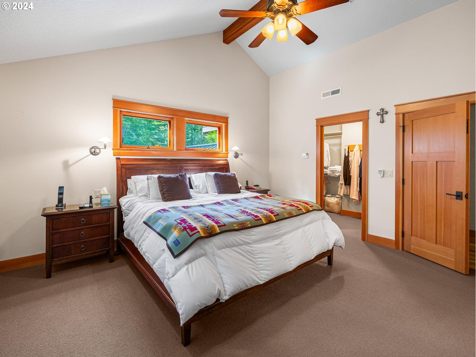 20803 East Glacier View Road Rhododendron, OR 97049 - Photo 26 of 48 a bedroom with a bed and a chandelier