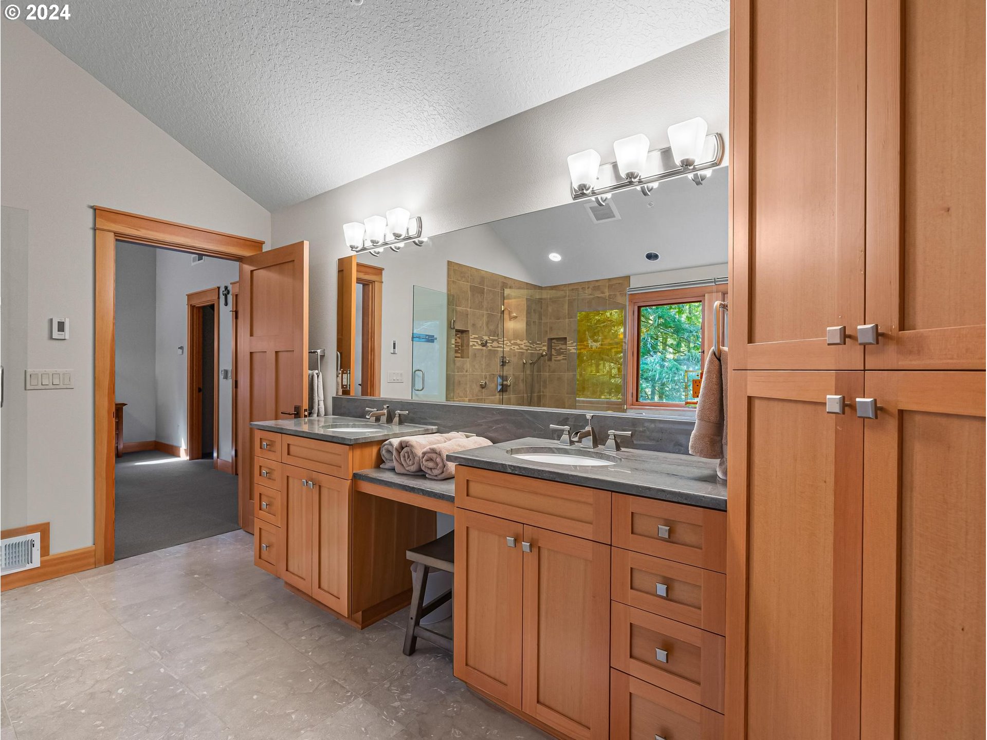 20803 East Glacier View Road Rhododendron, OR 97049 - Photo 27 of 48 a bathroom with a granite countertop sink a large mirror and a shower