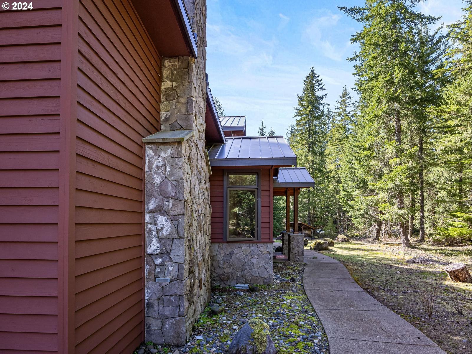 20803 East Glacier View Road Rhododendron, OR 97049 - Photo 35 of 48 a front view of a house with a garden
