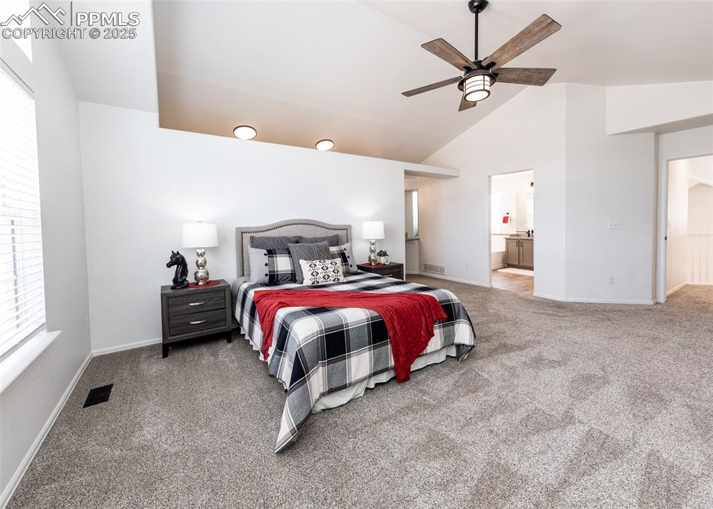 508 Fox Run Circle Colorado Springs, CO 80921 - Photo 32 of 50 a spacious bedroom with a bed and a chandelier