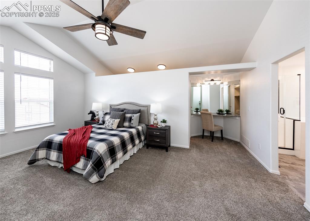 508 Fox Run Circle Colorado Springs, CO 80921 - Photo 33 of 50 a spacious bedroom with a bed and a chandelier