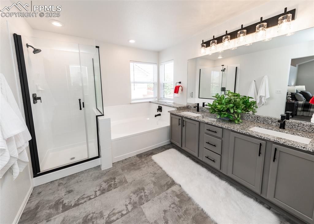 508 Fox Run Circle Colorado Springs, CO 80921 - Photo 36 of 50 a spacious bathroom with a granite countertop sink mirror shower and bathtub