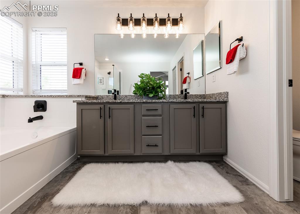 508 Fox Run Circle Colorado Springs, CO 80921 - Photo 37 of 50 a bathroom with a sink vanity and mirror