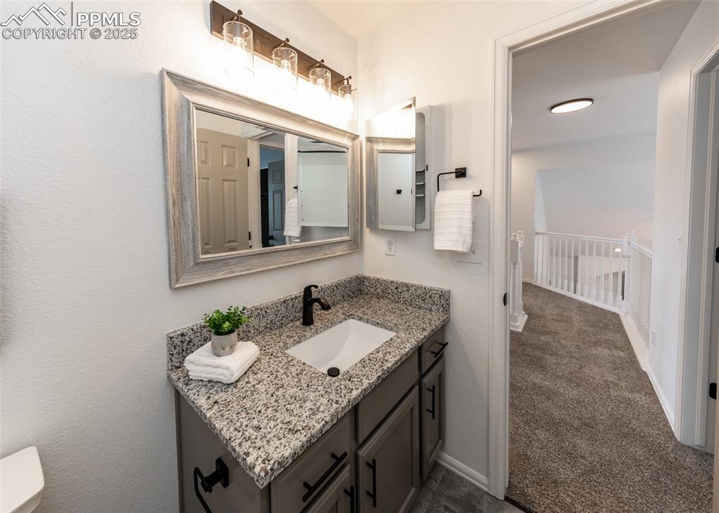 508 Fox Run Circle Colorado Springs, CO 80921 - Photo 43 of 50 a bathroom with a granite countertop sink and a mirror