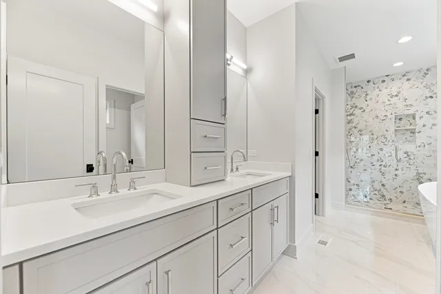 a bathroom with a sink double vanity and shower