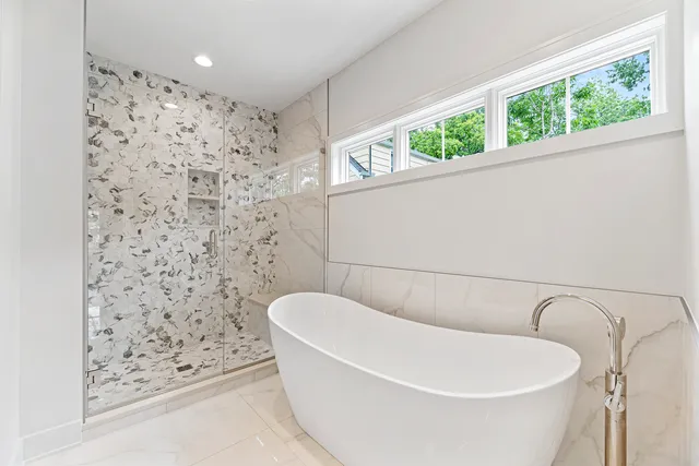 a bathroom with a bathtub and window