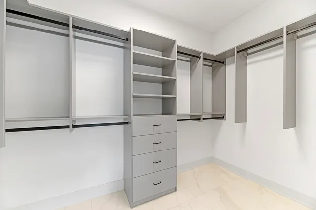 a view of walk in closet with empty racks
