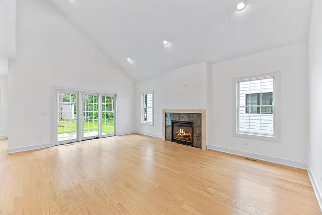 a view of an empty room with a fireplace and a window