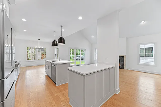 a kitchen with a sink stove and wooden floor