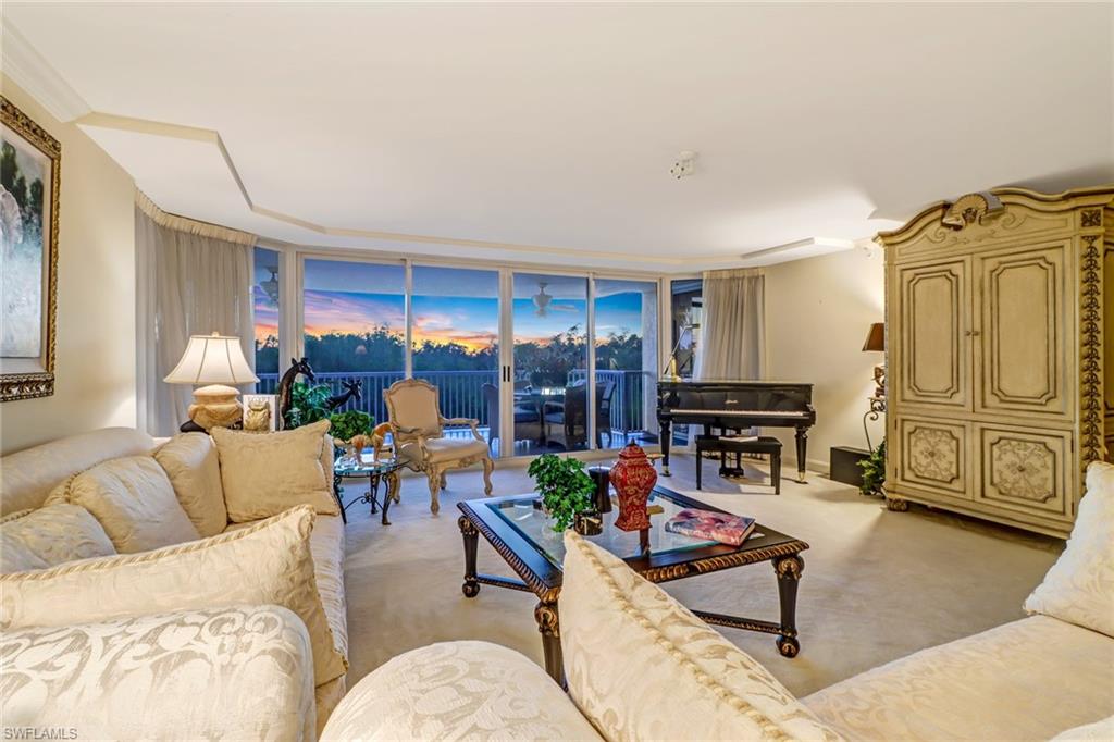 6849 Grenadier Boulevard, Unit 201 Naples, FL 34108 - Photo 8 of 35 a living room with furniture and a flat screen tv