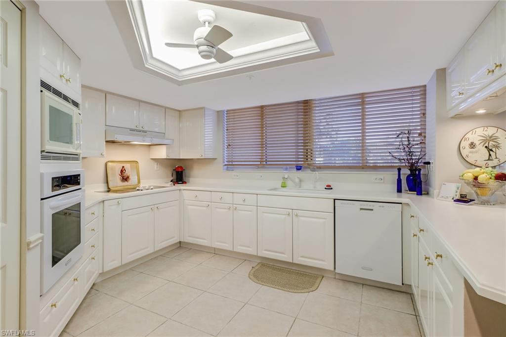 6849 Grenadier Boulevard, Unit 201 Naples, FL 34108 - Photo 9 of 35 a kitchen with cabinets and window