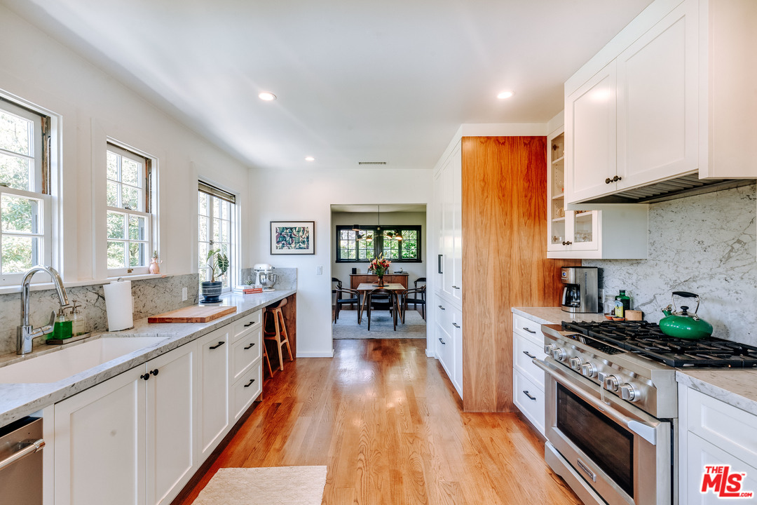 1341 Edgecliffe Drive Los Angeles, CA 90026 - Photo 17 of 51 a kitchen with stainless steel appliances granite countertop sink stove top oven and cabinets