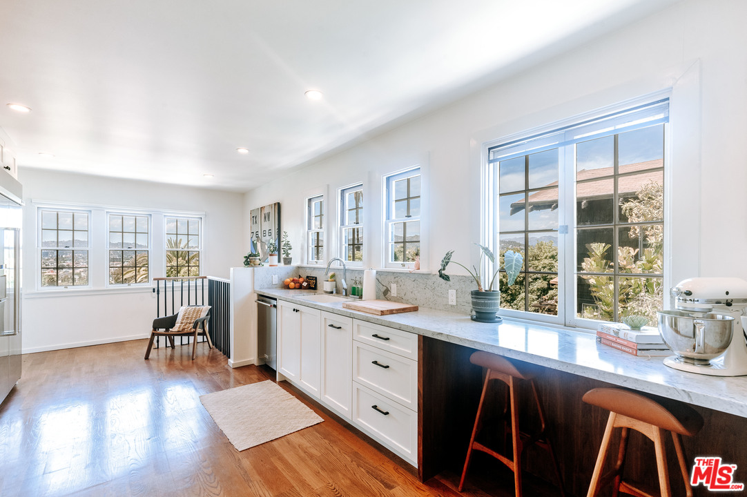 1341 Edgecliffe Drive Los Angeles, CA 90026 - Photo 18 of 51 a open dining room with stainless steel appliances furniture large window and wooden floor