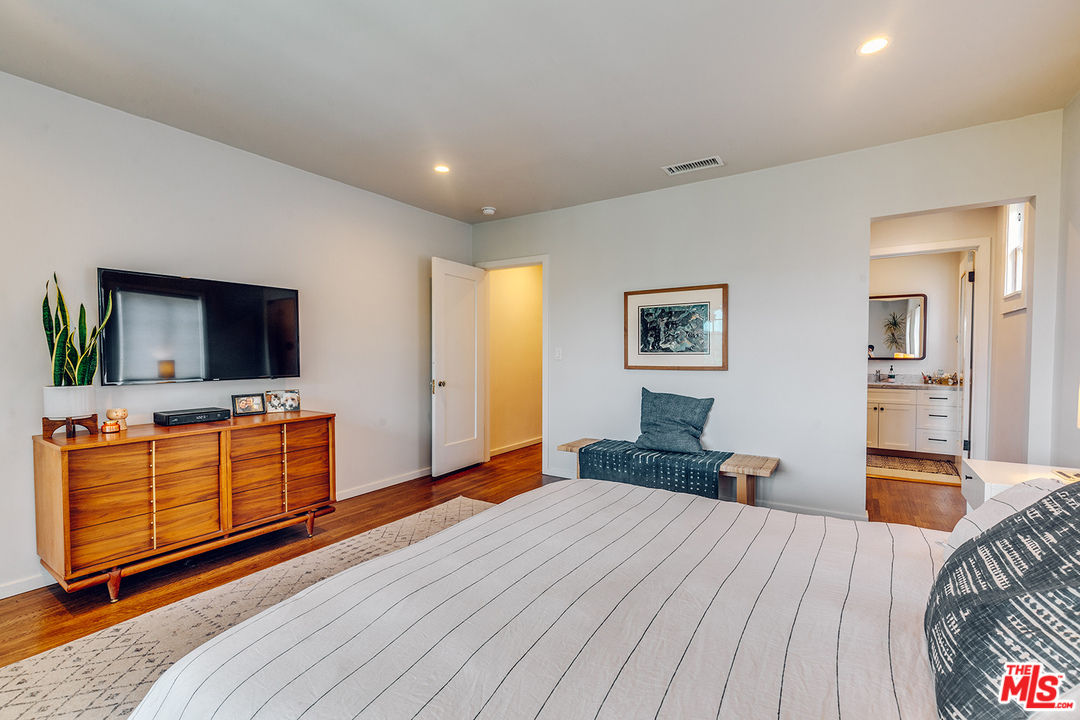 1341 Edgecliffe Drive Los Angeles, CA 90026 - Photo 22 of 51 a bedroom with a bed and wooden floor