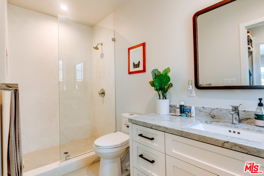 1341 Edgecliffe Drive Los Angeles, CA 90026 - Photo 23 of 51 a bathroom with a granite countertop sink a toilet and shower