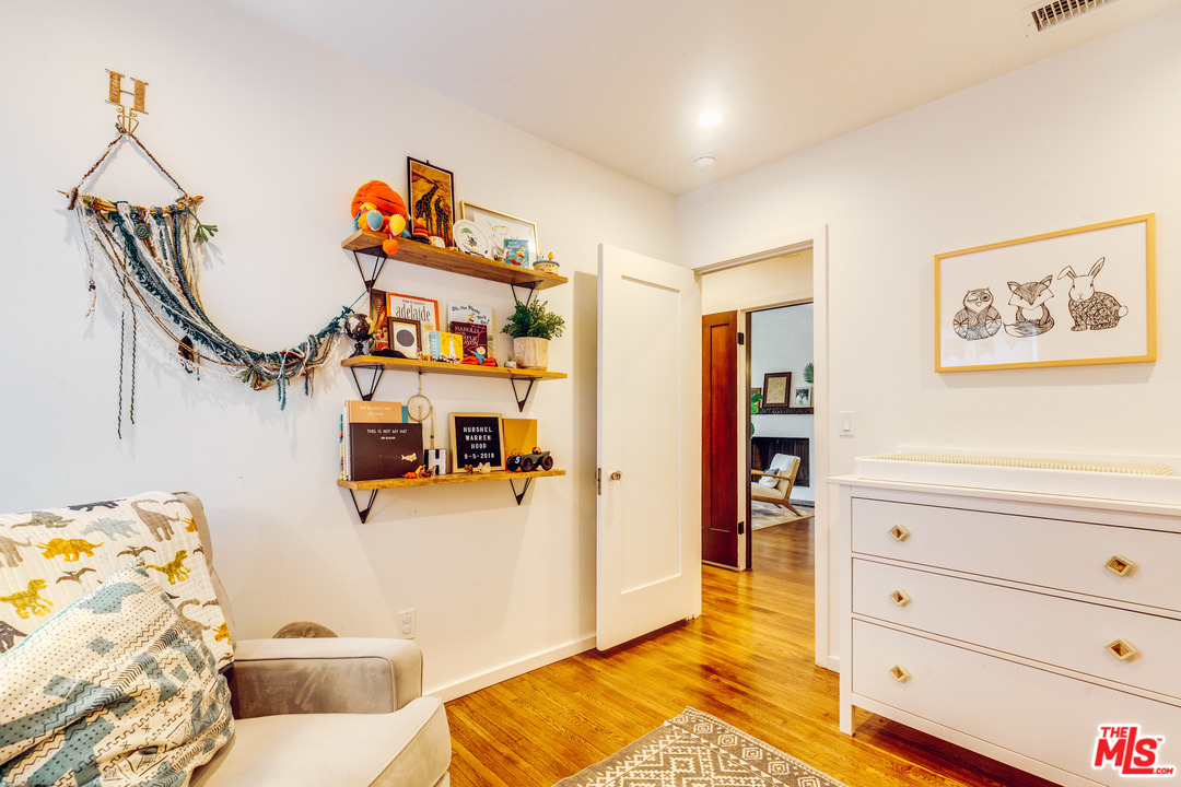 1341 Edgecliffe Drive Los Angeles, CA 90026 - Photo 31 of 51 a view of a bedroom with baby crib and lounge chair