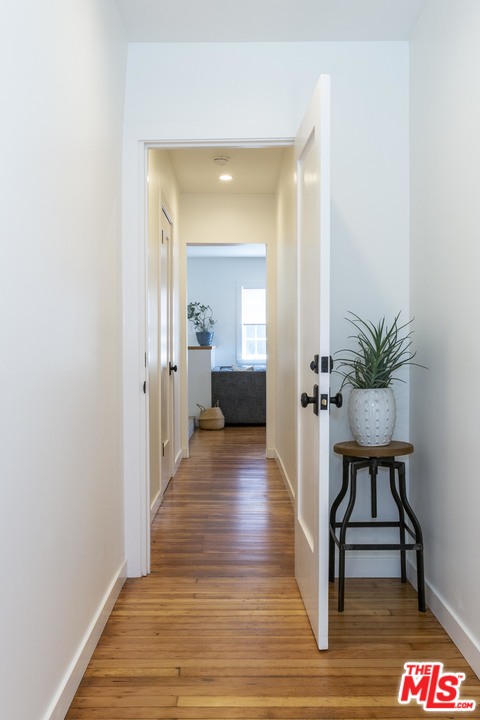 1341 Edgecliffe Drive Los Angeles, CA 90026 - Photo 46 of 51 a view of a hallway with wooden floor and a potted plant