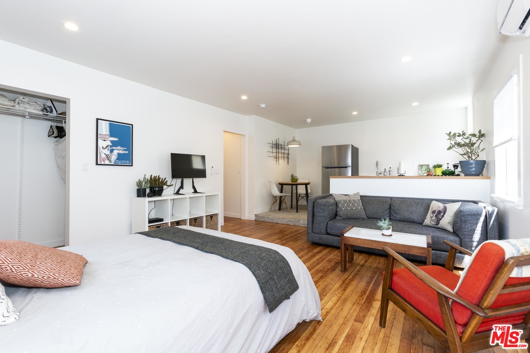 1341 Edgecliffe Drive Los Angeles, CA 90026 - Photo 48 of 51 a bedroom with a bed a couch and a flat screen tv