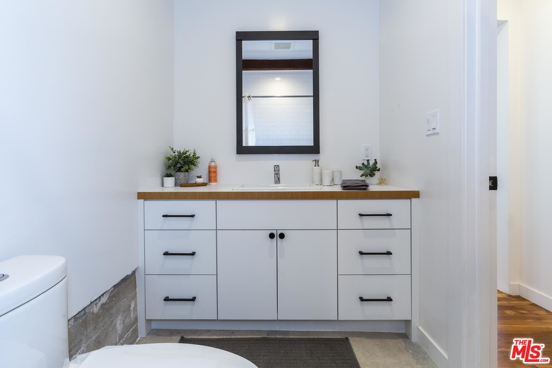 1341 Edgecliffe Drive Los Angeles, CA 90026 - Photo 51 of 51 a bathroom with a sink a toilet and mirror