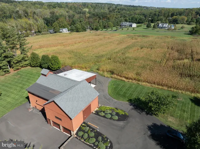 an aerial view of a house with big yard